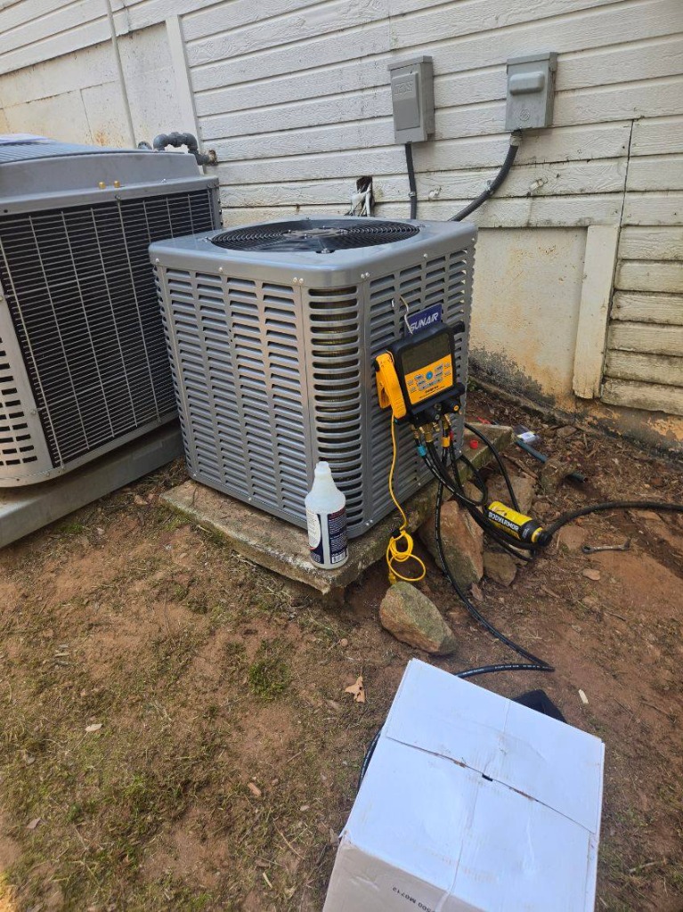 Technician checking HVAC gauges during service