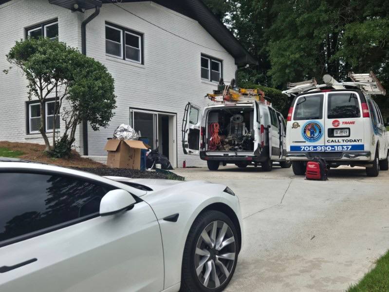Glacier Comfort Experts vans at a Georgia home