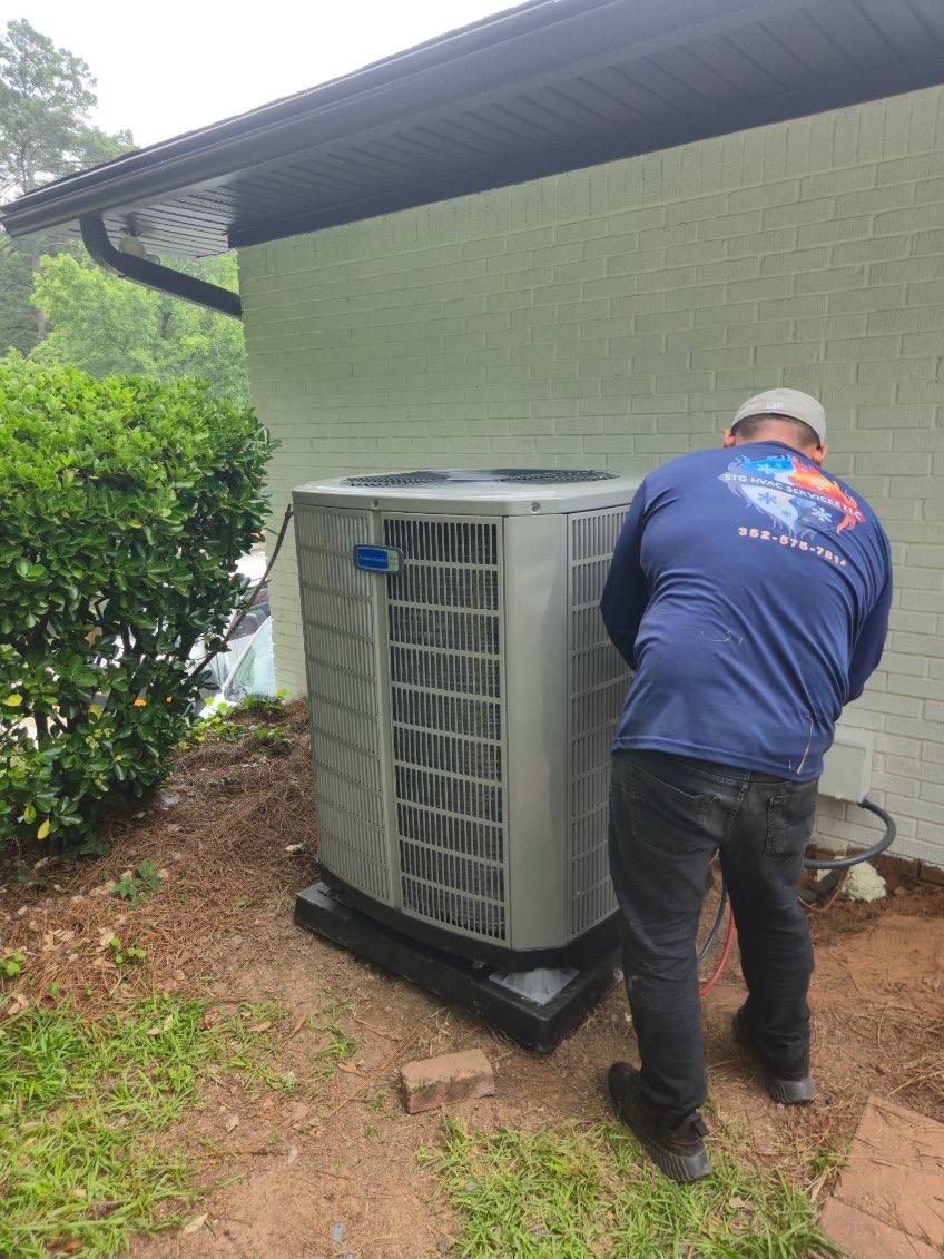 Outdoor condenser being tested with service gauges