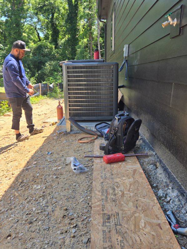 Technician working at an outdoor condenser